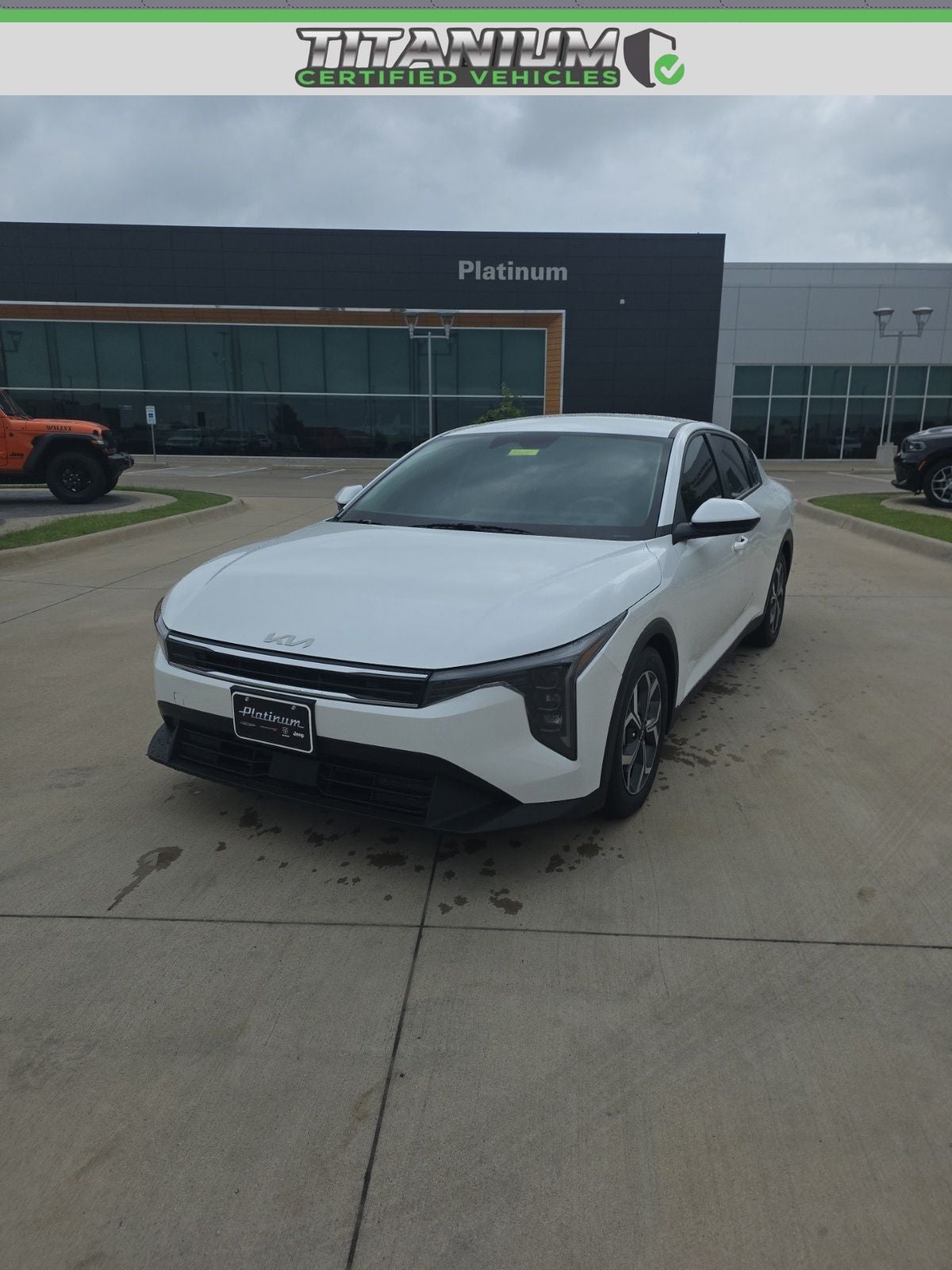 2025 Kia K4 EX in Snow White Pearl — front three-quarter view