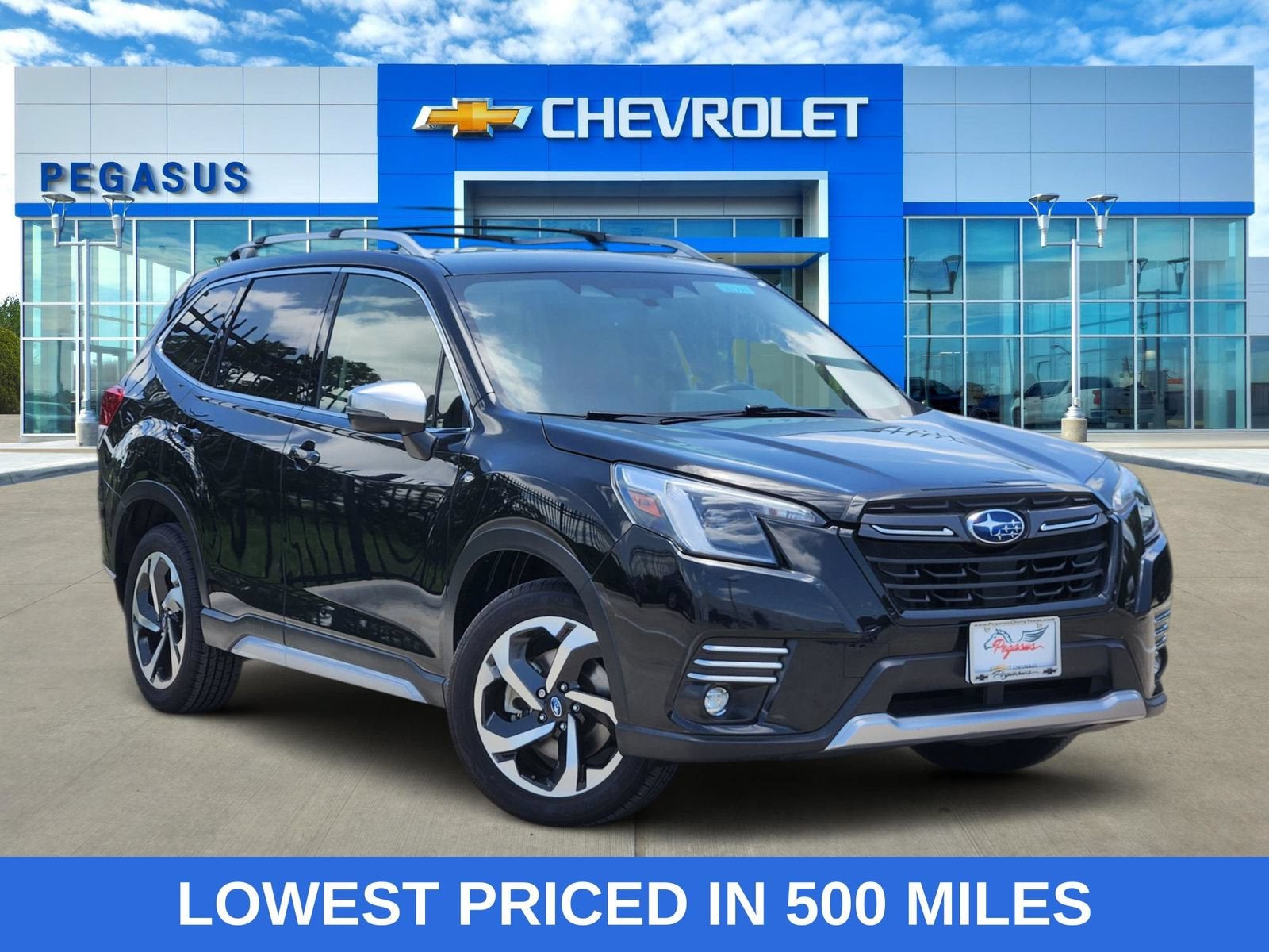 2024 Subaru Forester Touring in Black — front three-quarter view